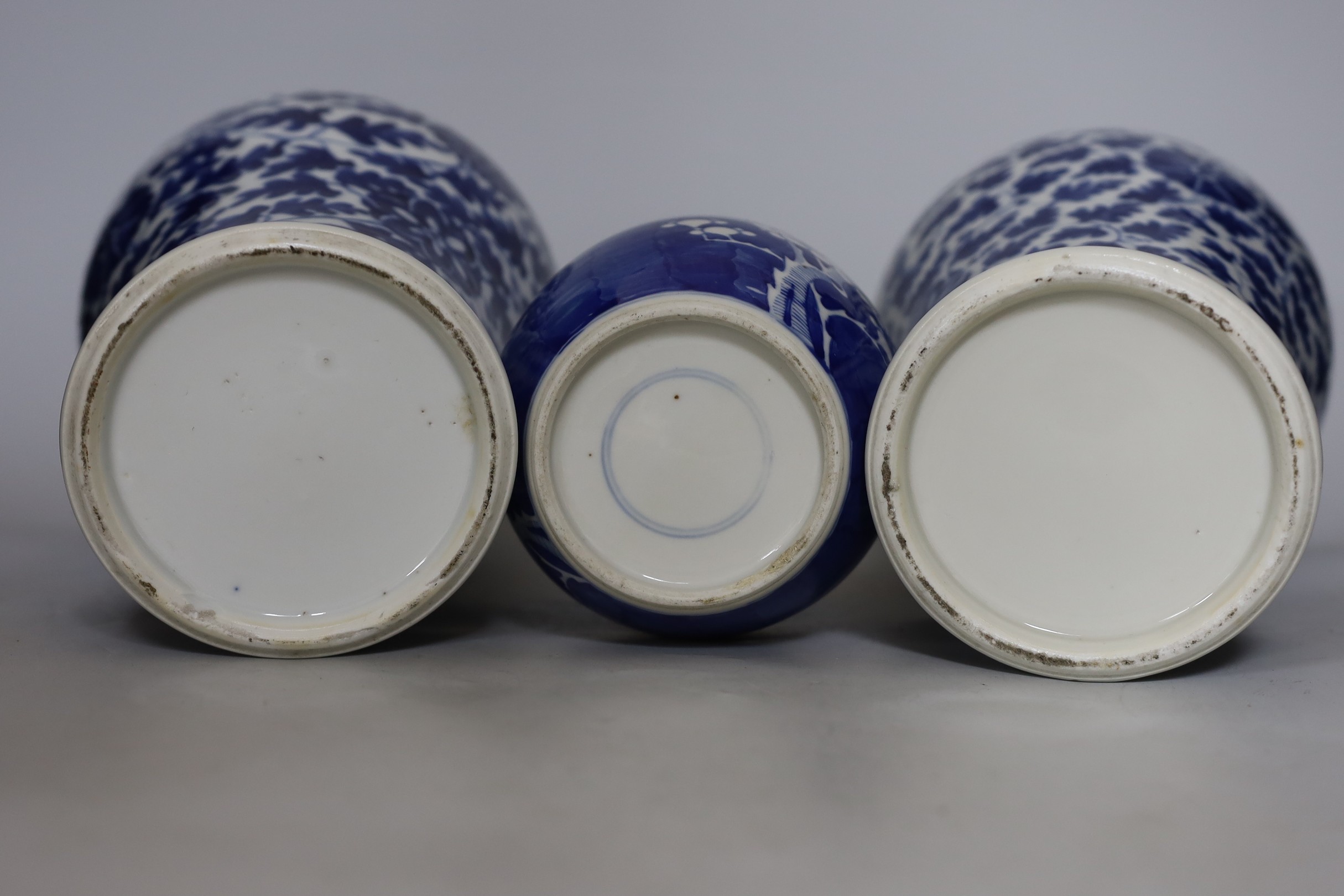 Two early 20th century Chinese blue and white vases with lion dog covers, together with a blue and white prunus jar and a pair of Japanese export flower dishes, and covers 33cm high
